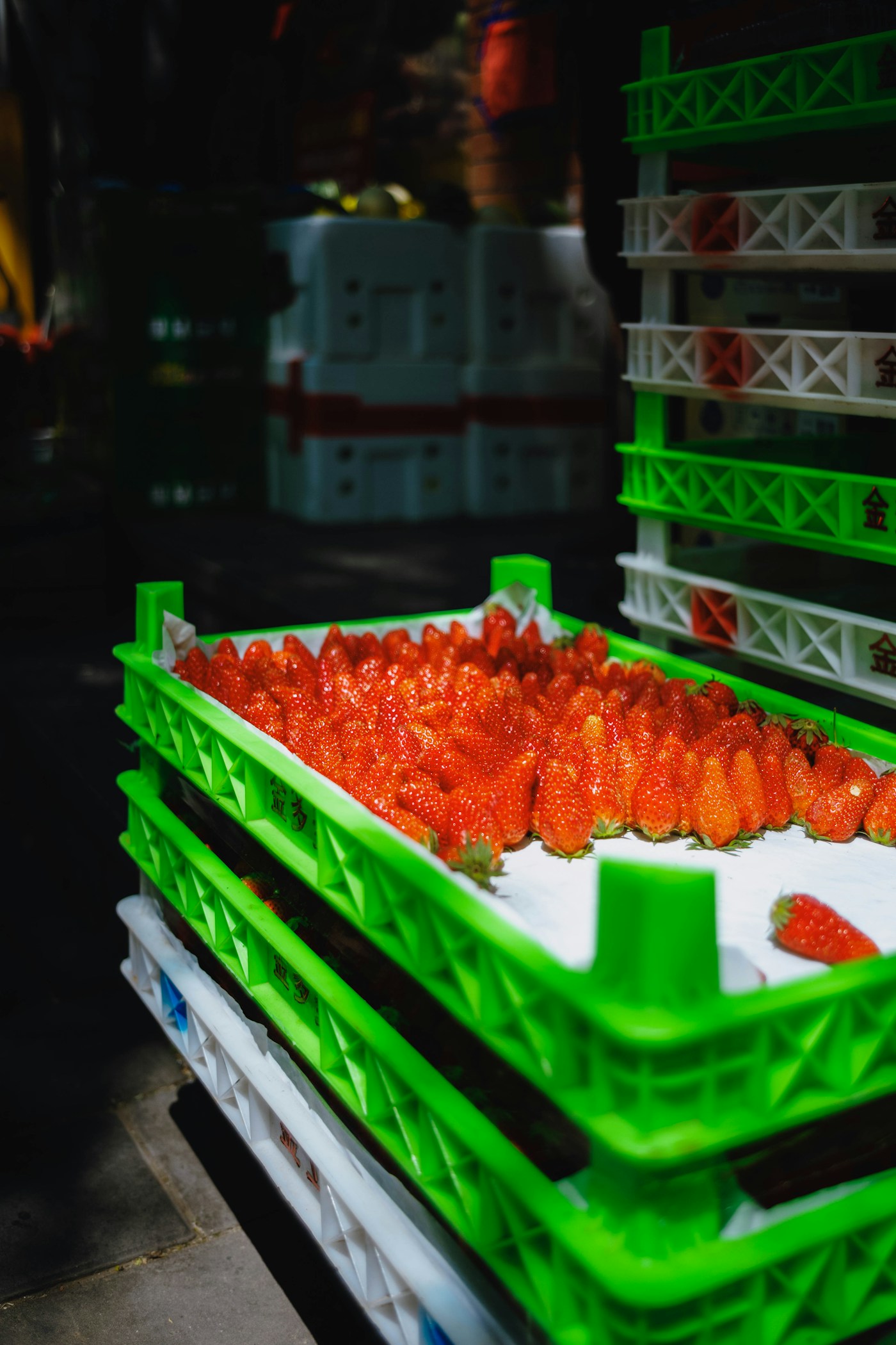 Fresh strawberries arranged in produce crates